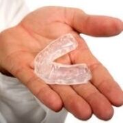 mouth guard for teeth cutting, which is a symptom of the presence of parasites